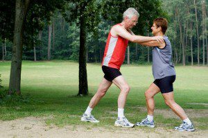 tandem lung couple stretch exercise park dreamstime 1073684