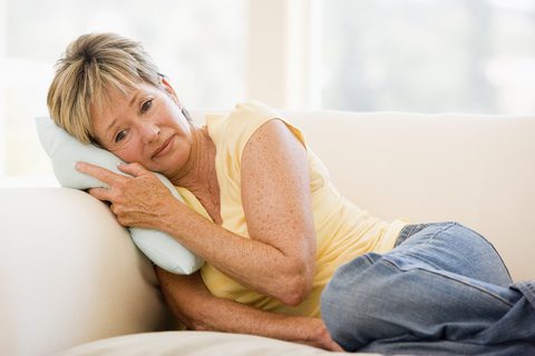 Distressed woman on couch dreamstime 7774199
